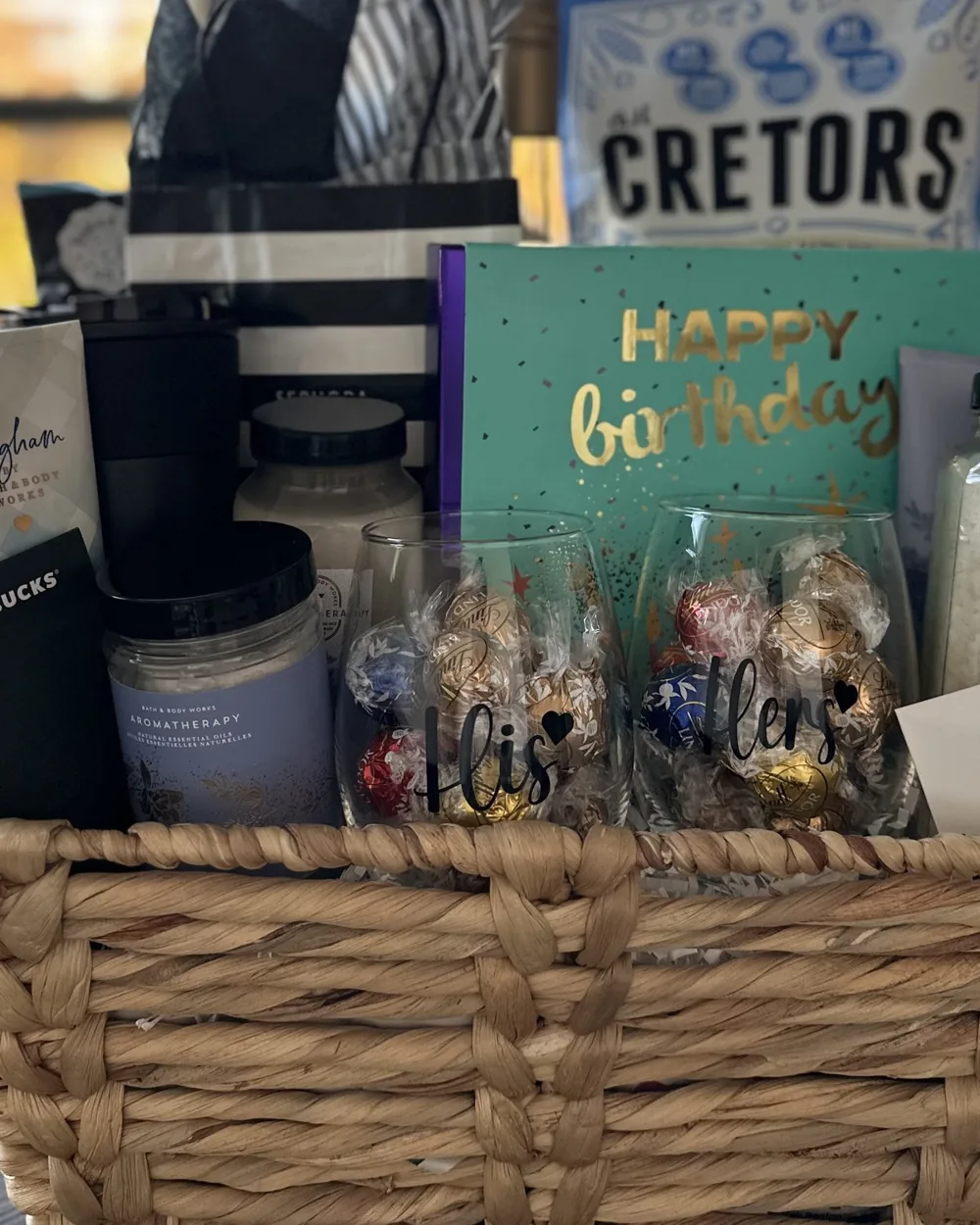 Birthday gift basket with popcorn, chocolates, a candle and a birthday card